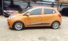 Hyundai Grand i10 1.2 AT 2016 - Cần bán xe Hyundai Grand i10 1.2 AT sản xuất năm 2016, màu cam, nhập khẩu nguyên chiếc, giá tốt