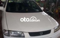 Mazda 323 2000 - Cần bán xe Mazda 323 đời 2000, màu trắng giá 68 triệu tại Đồng Nai